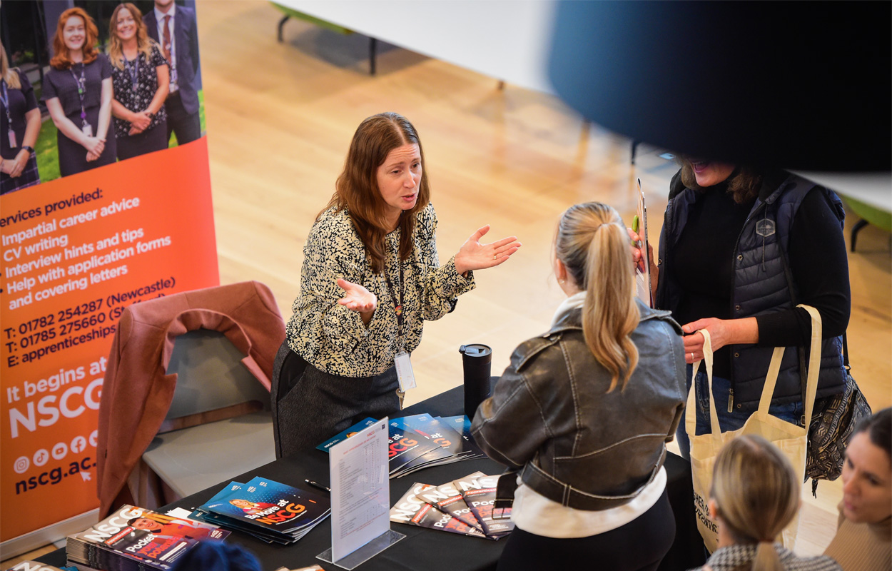 Prospective apprentices are chatting about opportunities at an employer stand