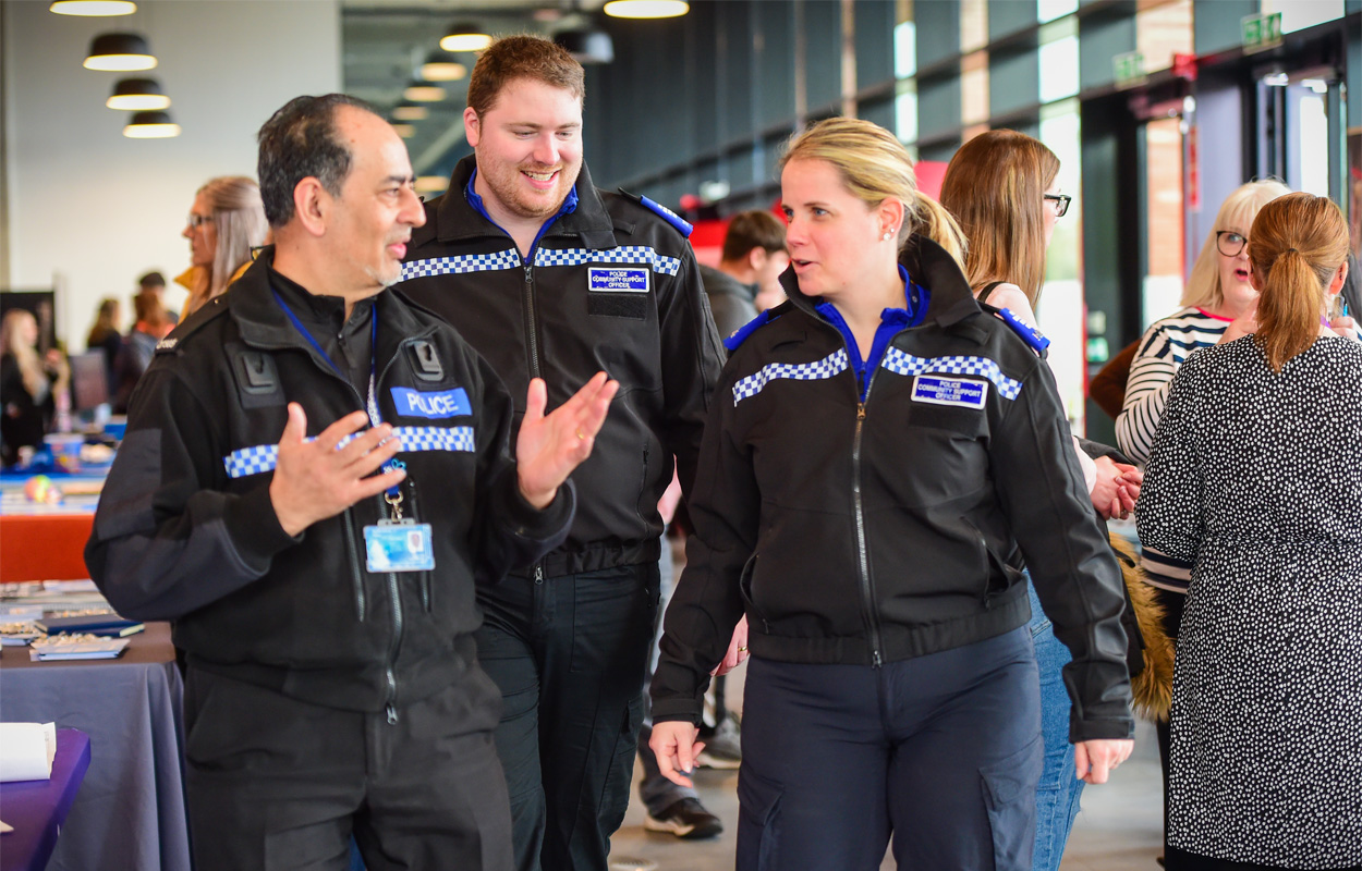 Three police staff dressed in uniform are attending the National Apprenticeship Week event