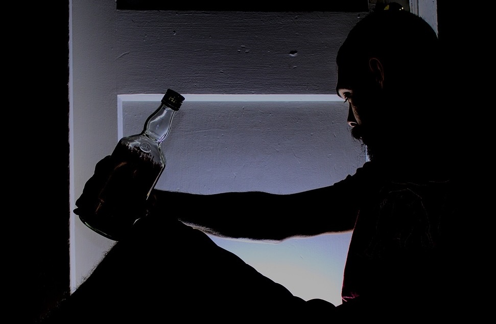 A man holding a bottle of alcohol