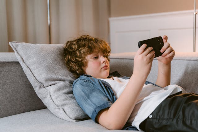 A young boy using a mobile phone