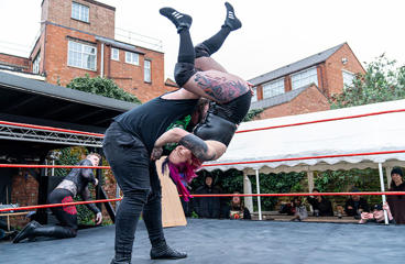 Two people wrestling in a ring