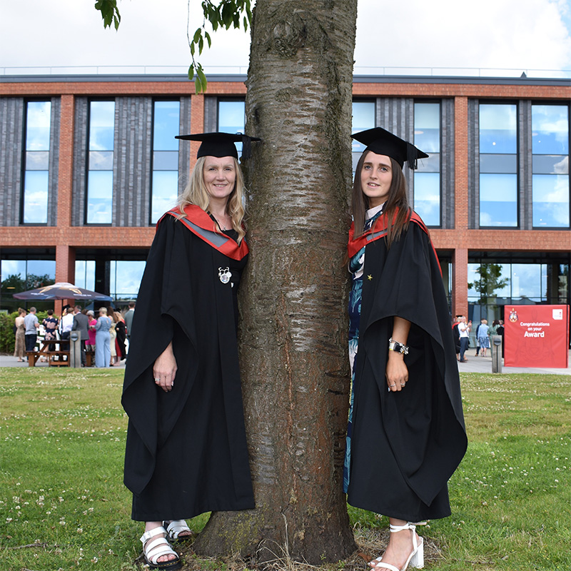 Zoe Tett and Georgia Boote pictured in their graduation caps and gowns