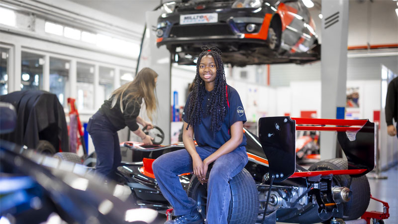 Two females are in the motorsports lab